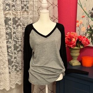 gray baseball style shirt with black sleeves
